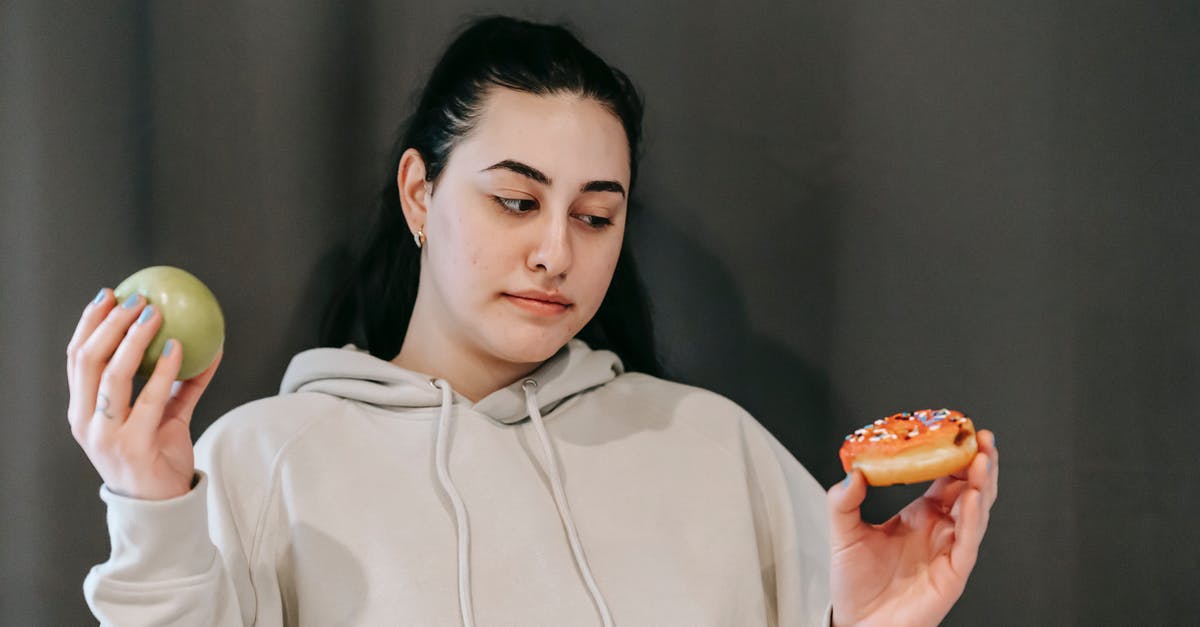 What is the criteria for the other donut option to become viable in Don't get fired? - Thoughtful woman choosing between green apple and sweet donut