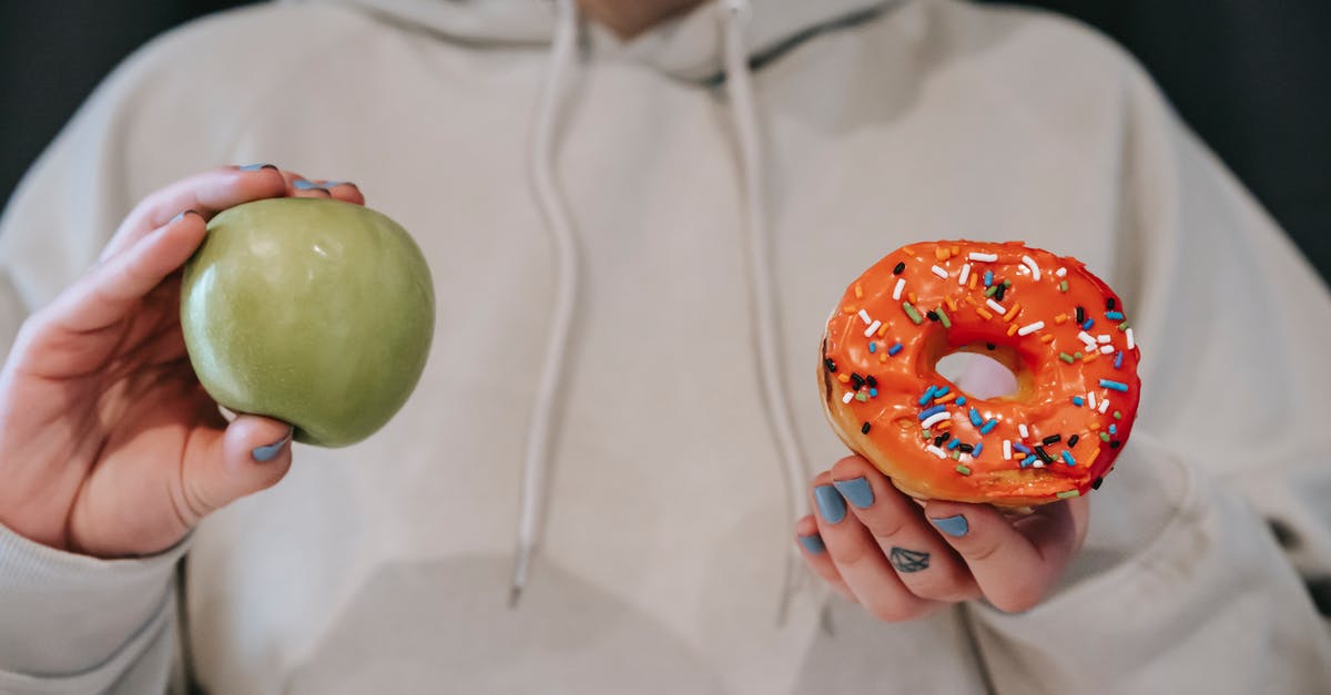 What is the criteria for the other donut option to become viable in Don't get fired? - Crop faceless woman demonstrating ripe green apple and sweet doughnut