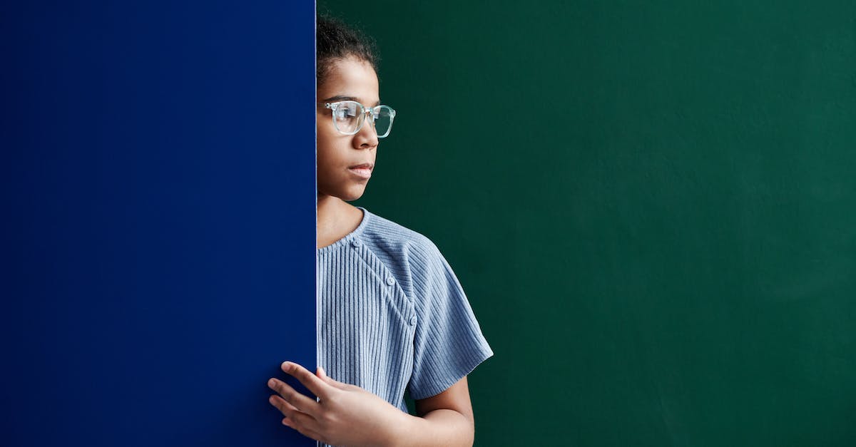 What is the difference between blue and striped blue-and-white defeated levels? - A Woman in Blue Shirt Standing Between Green and Blue Wall What is the difference between blue and striped blue-and-white defeated levels? - A Woman in Blue Shirt Standing Between Green and Blue Wall