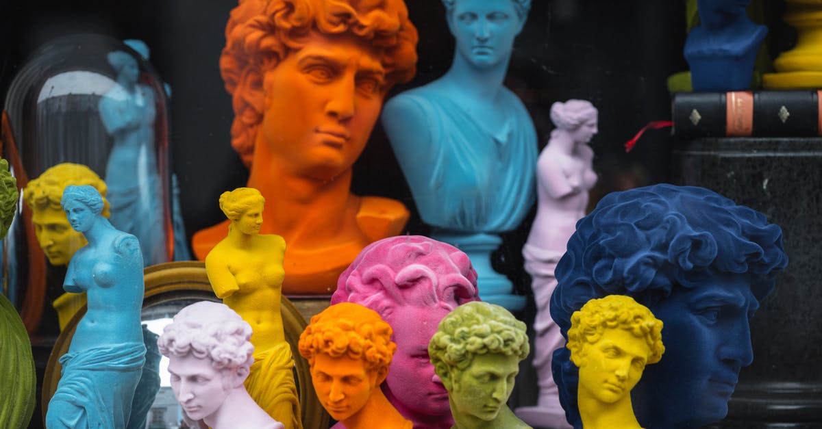 What is the difference between Freeciv's classic and default ruleset? - Multicolored head sculptures of David near bright statuettes placed in store with abundance of souvenirs and black pillar with book