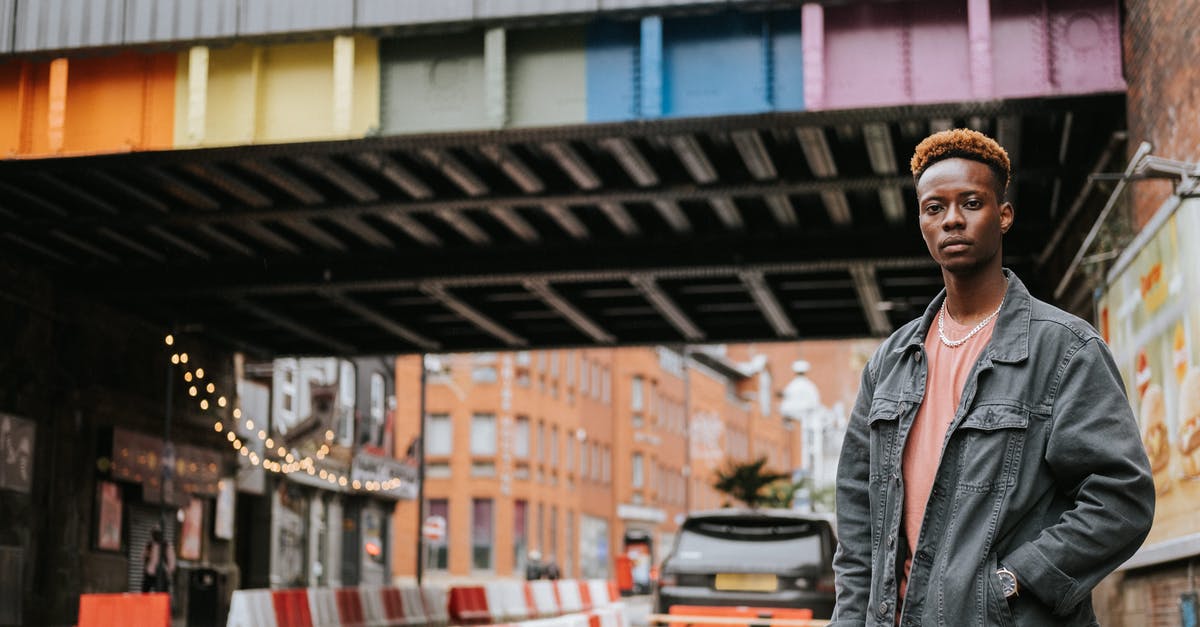 What is the difference between Intense Rainbow dye and normal rainbow dye? - Black man standing near city bridge painted in rainbow colors