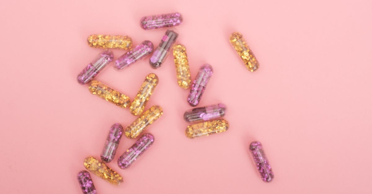 What is the difference between Mario and Doctor Mario? - Heap of colorful glitter filled capsules on pink background What is the difference between Mario and Doctor Mario? - Heap of colorful glitter filled capsules on pink background