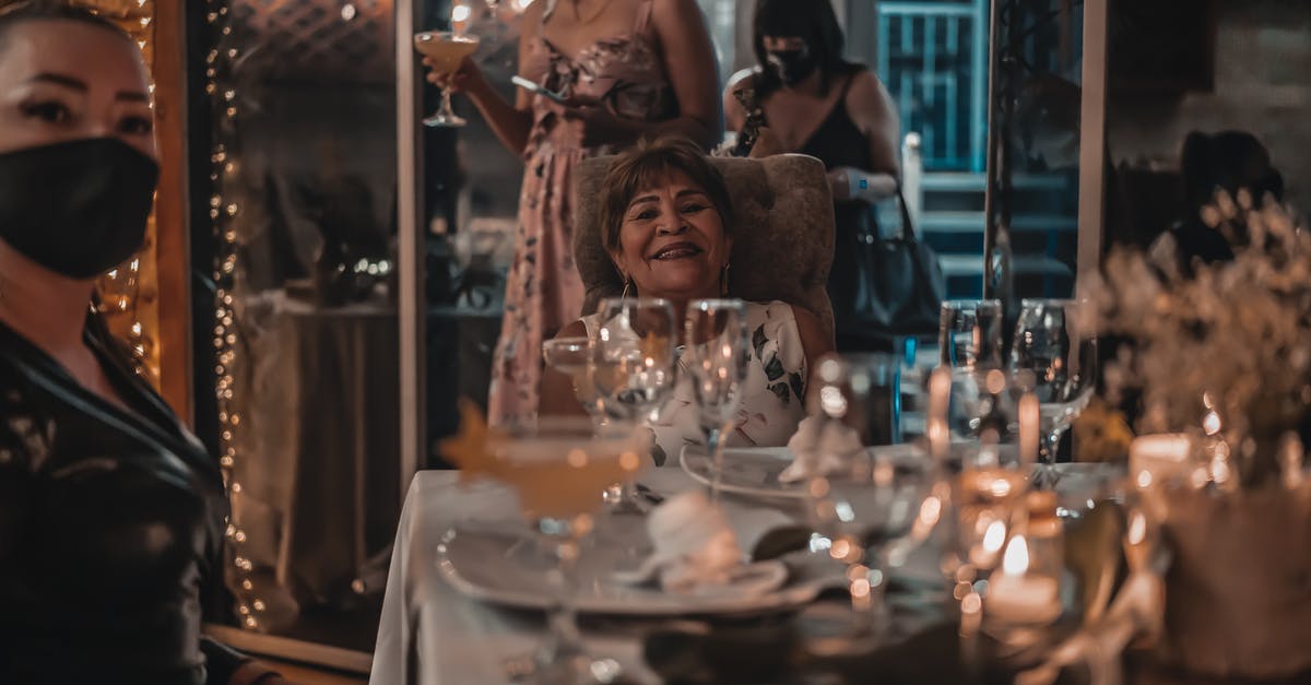 What is the difference between normal and special edition? - Happy elderly woman celebrating festive event among friends at table
