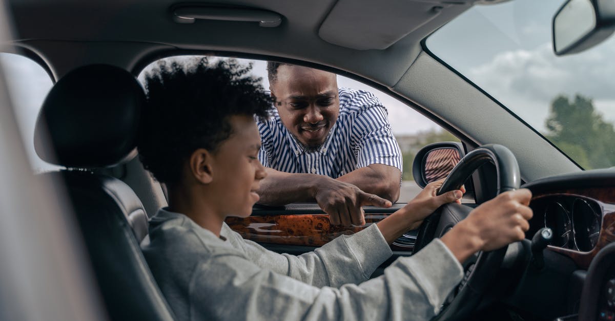 What is the difference between the two Driver discs? - Man in Blue and White Striped Dress Shirt Sitting on Car Seat