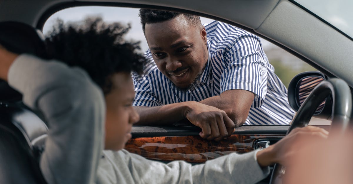 What is the difference between the two Driver discs? - Man in White and Blue Striped Dress Shirt Sitting on Car Seat