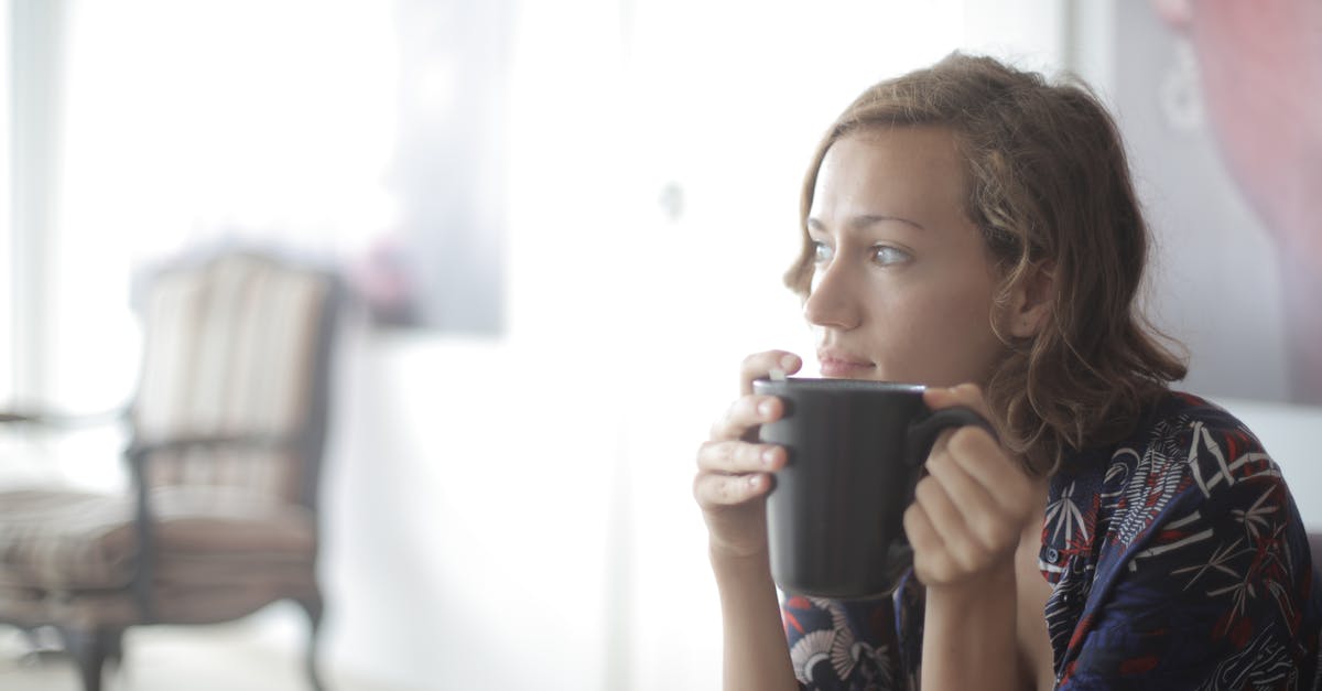 What is the differences between being home and away? - Girl in Black and Pink Floral Tank Top Drinking from Black Ceramic Mug