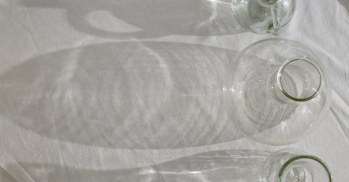 What is the effect of equipment position? - Empty clean shiny glassware on white fabric What is the effect of equipment position? - Empty clean shiny glassware on white fabric