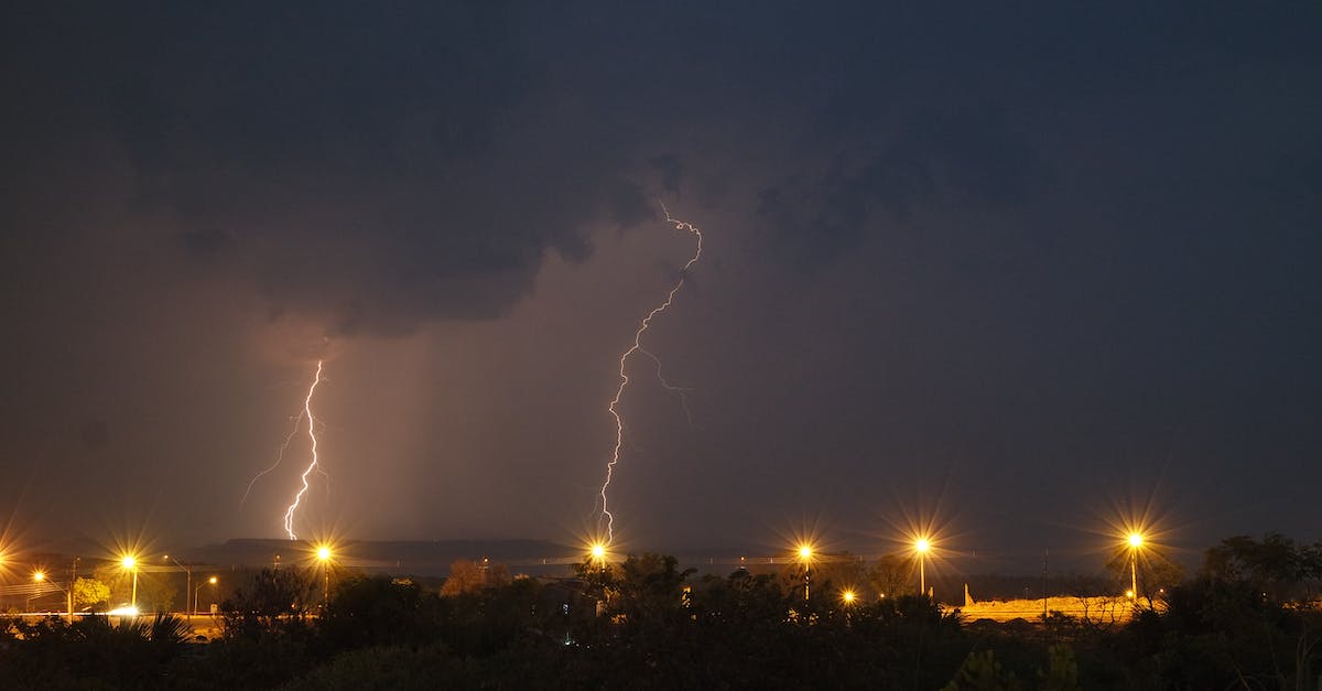 What is the effect of increasing the power budget vs building a new power plant? - Lightning over dark city with buildings