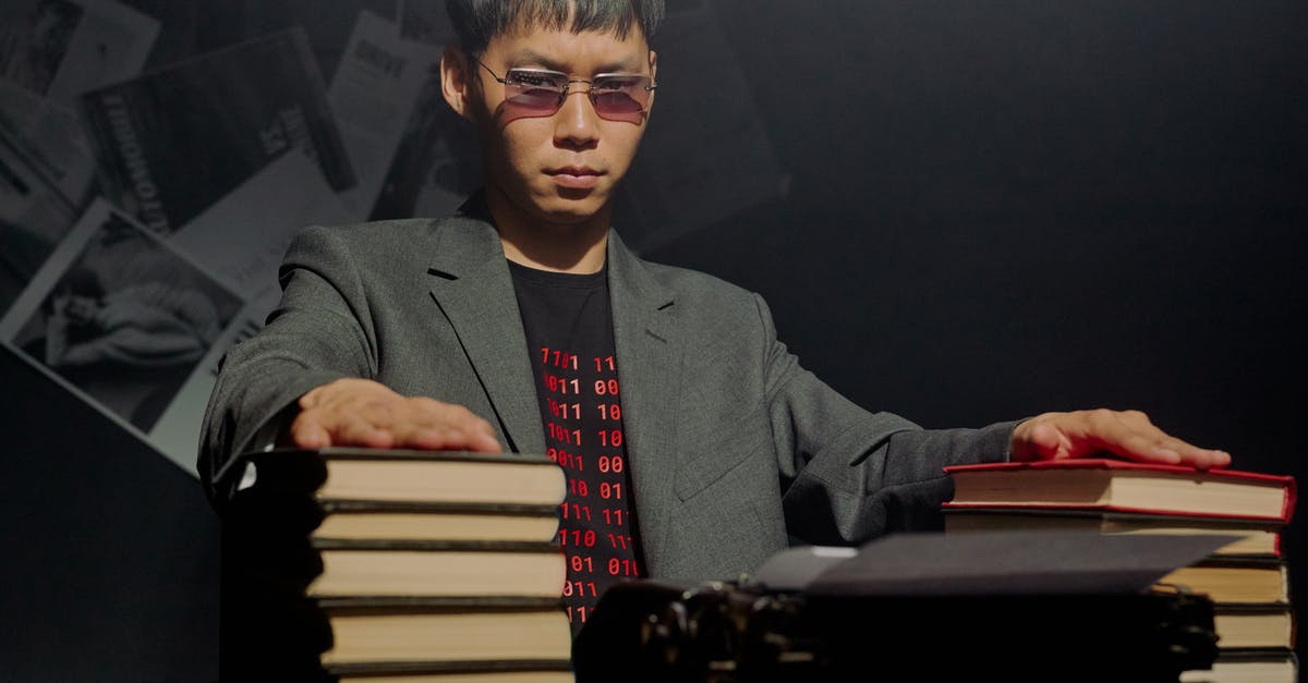 What is The Eldritch Truth? - Stacks of Books in Front a Serious Man 