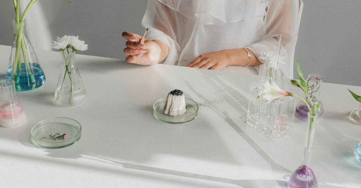 What is the expected CP after evolving an Eevee with 376 CP? - Unrecognizable Woman Sitting at Table after Chemical Experiment