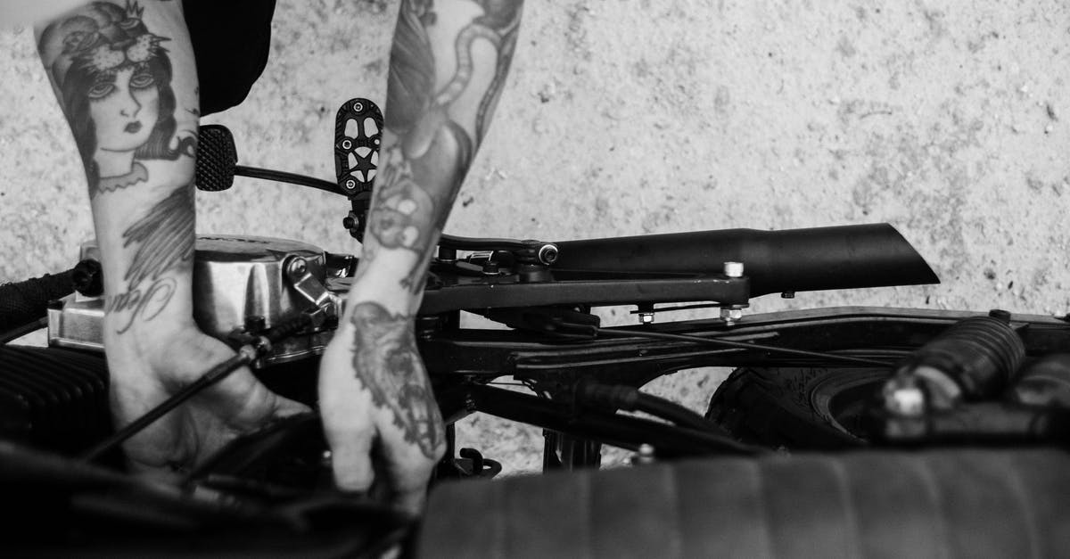 What is the fastest vehicle setup from the Catch-A-Ride? - Tattooed biker fixing engine of motorcycle What is the fastest vehicle setup from the Catch-A-Ride? - Tattooed biker fixing engine of motorcycle