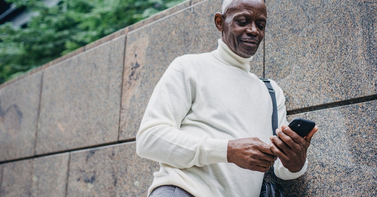 What is the Holo Caster message after you beat the Gym Leader in Lumiose City? - Black man using mobile phone on street