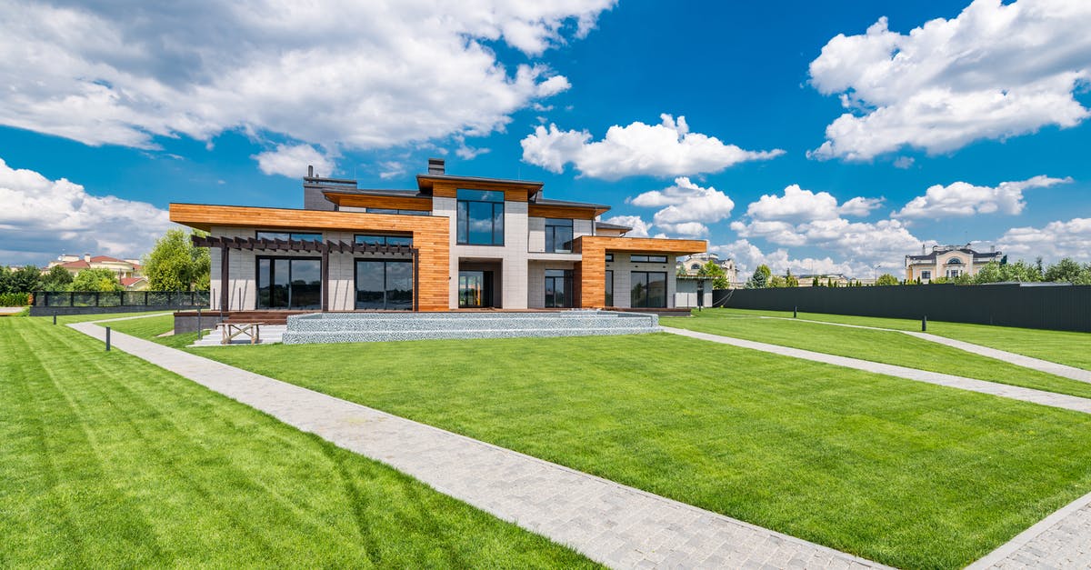 What is the jizo in the main courtyard for? - Picturesque landscape of villas with green lawn and cobblestone paths on background of cloudy blue sky What is the jizo in the main courtyard for? - Picturesque landscape of villas with green lawn and cobblestone paths on background of cloudy blue sky