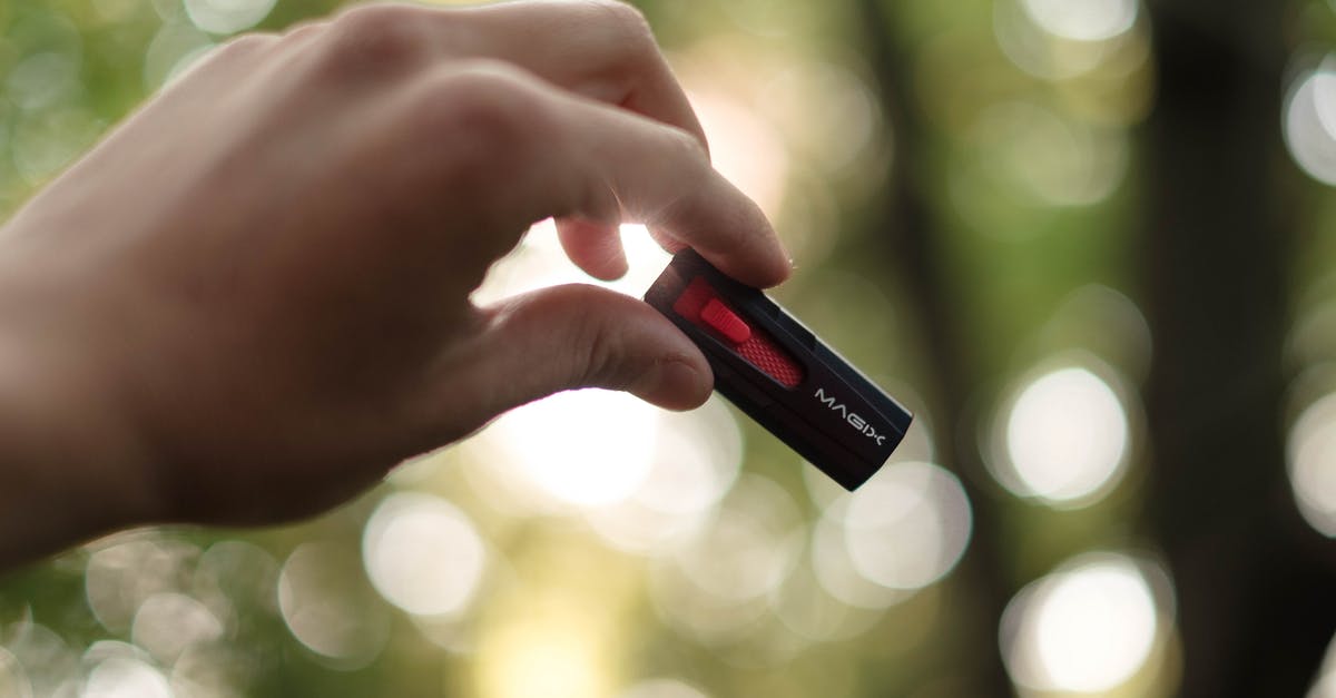 What is the jump key? - Unrecognizable person showing USB on blurred background