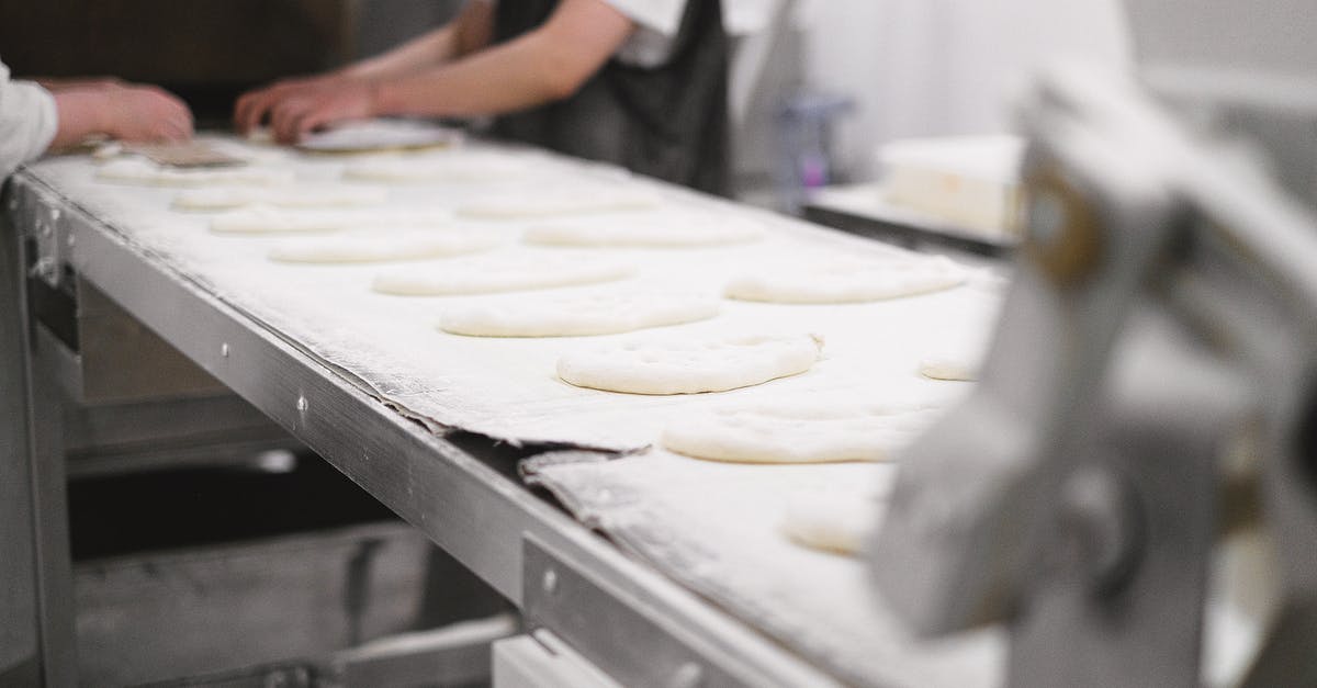 What is the lava thing for in the industrial centrifuge - Person in White Apron Holding White Dough What is the lava thing for in the industrial centrifuge - Person in White Apron Holding White Dough