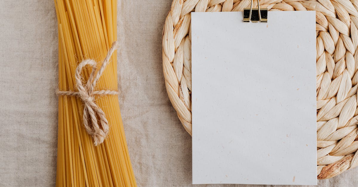 What is the list of ingredients for recipe #99? - From above of blank paper placed on wicker table mat next to spaghetti tied with bow arranged on table covered with linen tablecloth suitable for recipe or ingredient listing