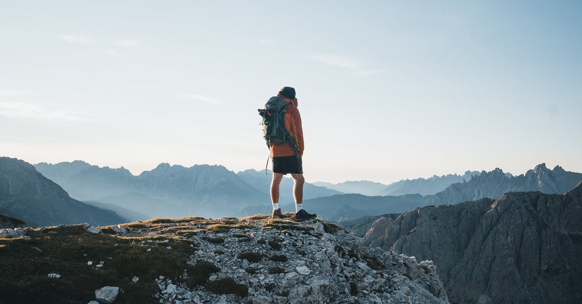 What is the max altitude of generated terrain? - Back view anonymous male explorer with backpack standing on rough mountain peak and enjoying breathtaking scenery of severe highland on clear day