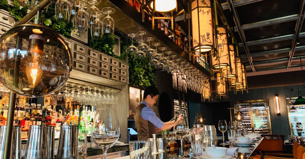 What is the maximum server View-Distance? - Side view concentrated professional barman wearing uniform working at bar counter in cozy fine dinning restaurant