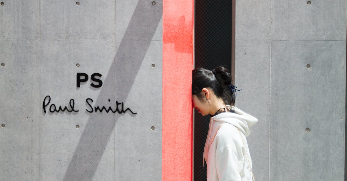 What is the most commonly used sign on the Name engraved ring? - Woman in White Hoodie