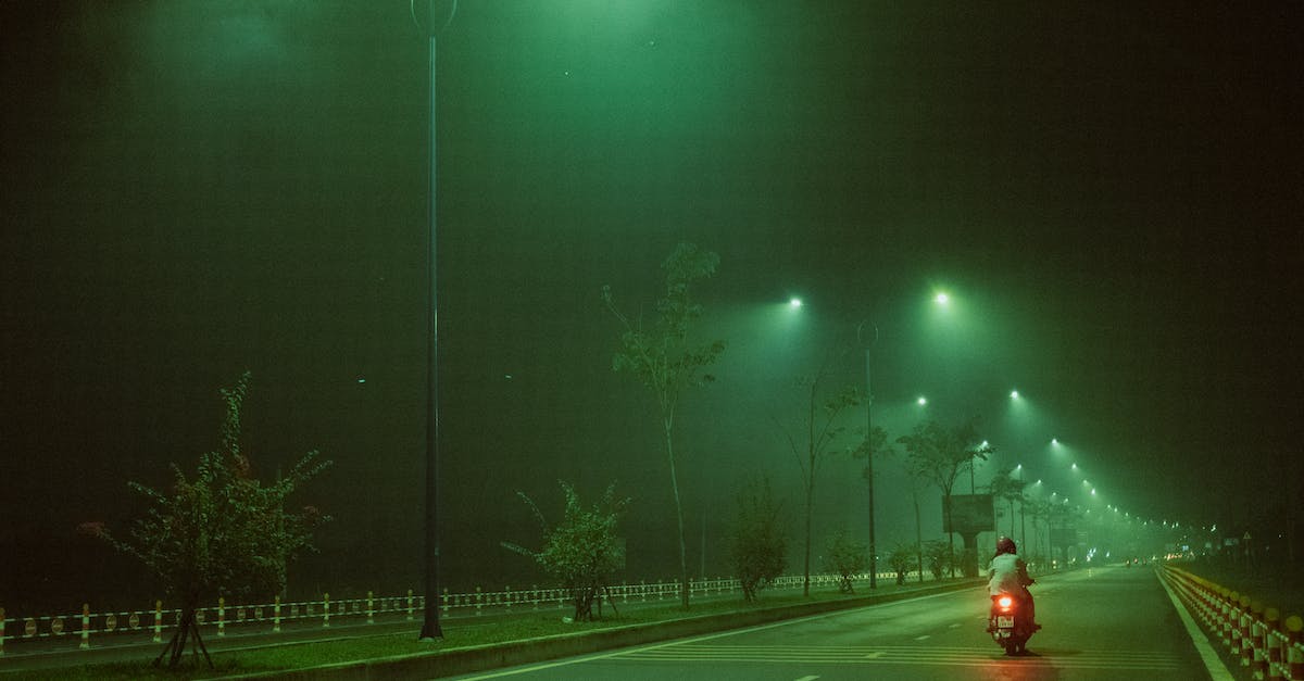 What is the most resource-efficient way to transfer power over long distances? - Unrecognizable person riding motorcycle at night