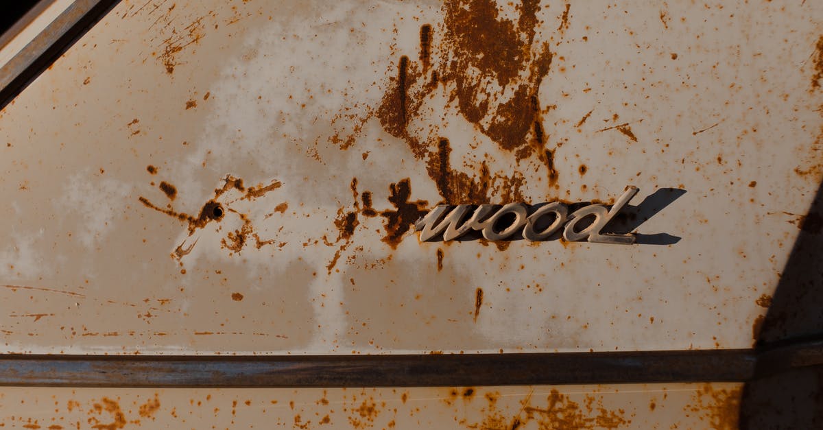 What is the name of this old shooting game? - Corroded stains on part of old automobile with fragment of brand name written by metal letters