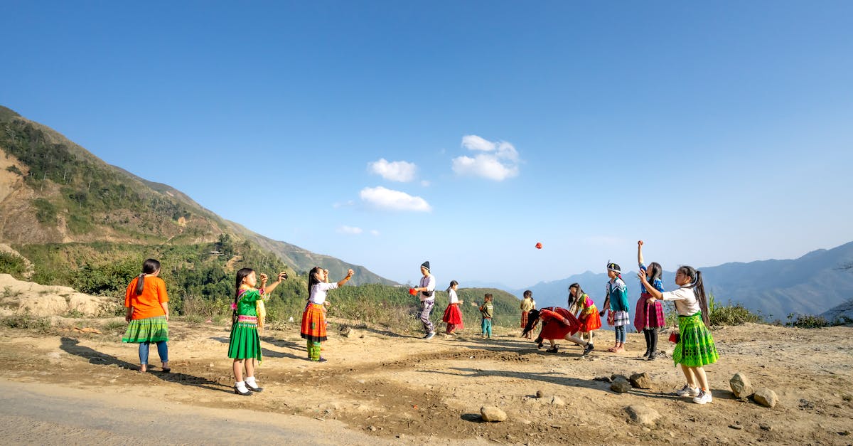 What is the native resolution for this game? - Group of local kids in colorful clothes throwing balls in air while playing near mountain ridge in countryside on summer day