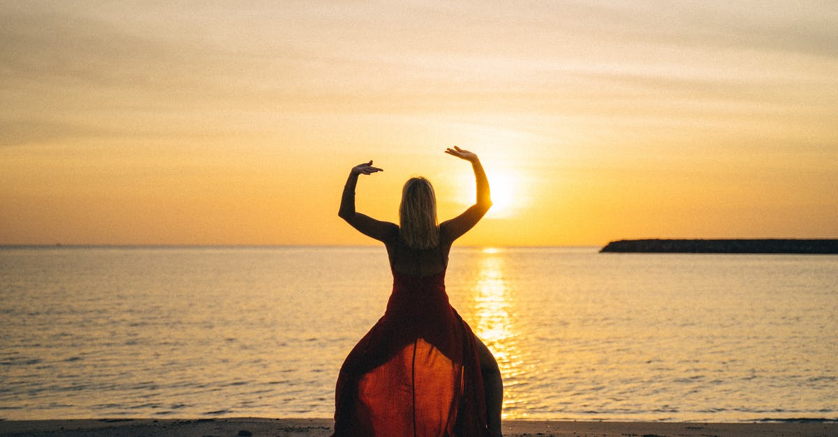 What is the newest version of Minecraft that still has Soul Sand features? - Back view of female with raised hands doing yoga standing on sandy beach with face towards calm sea and sunset in summertime
