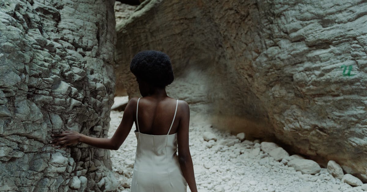 What is the number by the Treasure Cave - Woman in White Spaghetti Strap Dress Standing in Front of Brown Rock Formation What is the number by the Treasure Cave - Woman in White Spaghetti Strap Dress Standing in Front of Brown Rock Formation