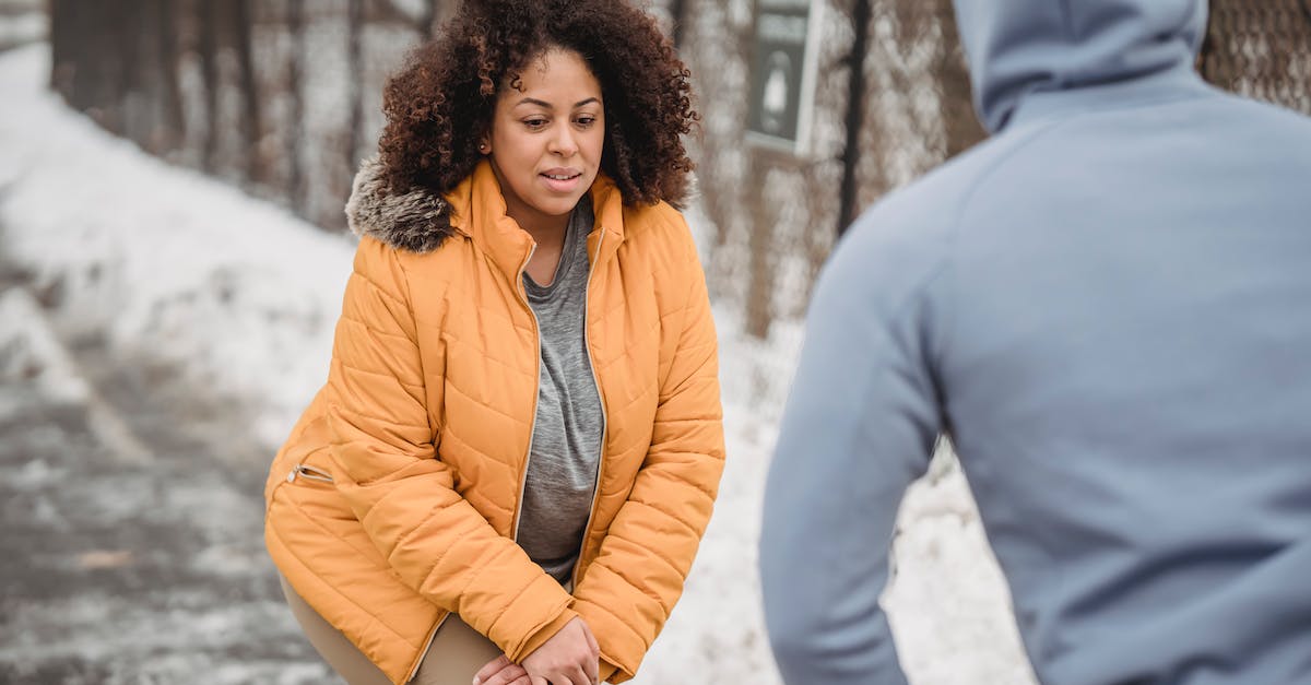 What is the optimal grid size? - Serious black woman warming up with anonymous trainer in snowy park What is the optimal grid size? - Serious black woman warming up with anonymous trainer in snowy park