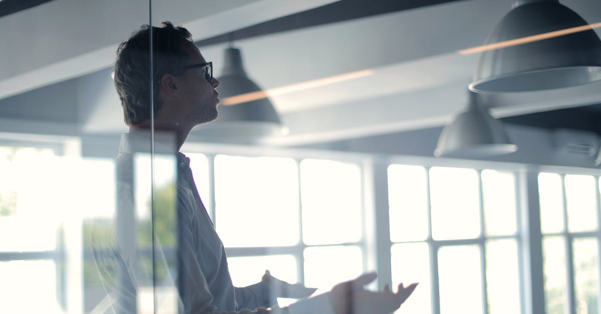 What is the point of having an alliance with your partner's family? - Male employer gesticulating and explaining idea in light office What is the point of having an alliance with your partner's family? - Male employer gesticulating and explaining idea in light office