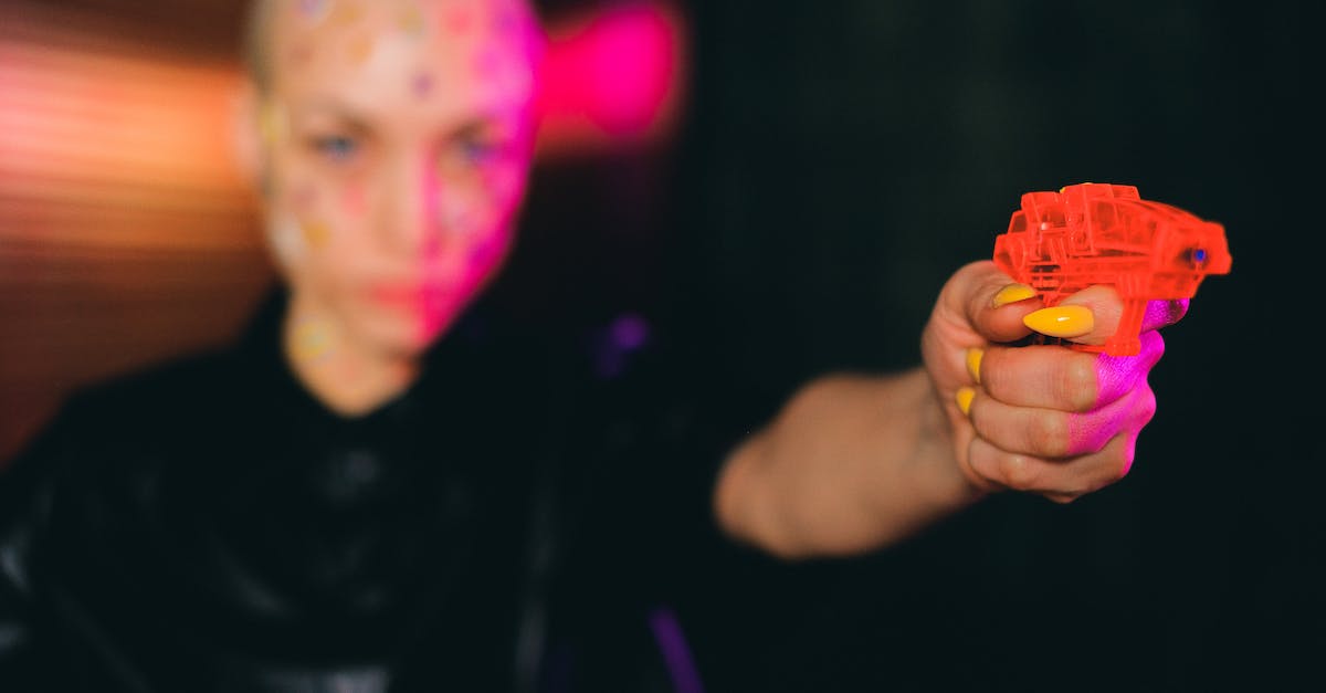 What is the point of the Anti-Gadoid gun in Dying Light? - Eccentric bald woman pointing toy gun in dark studio