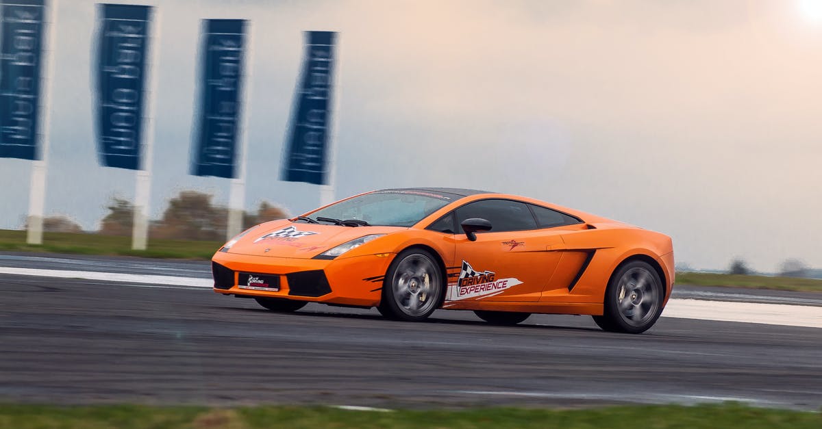 What is the proper way not to scare civilians? - Modern luxury orange sports car riding fast on asphalt highway at race at daytime under bright sky