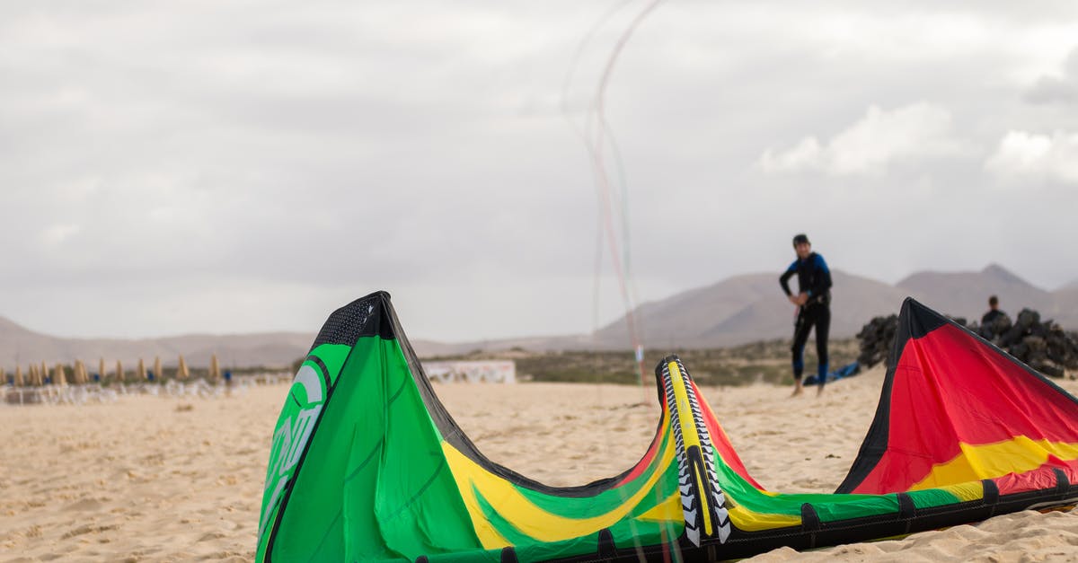 What is the purpose of Large Gems? - Man Playing with Large Kite on Bea What is the purpose of Large Gems? - Man Playing with Large Kite on Bea