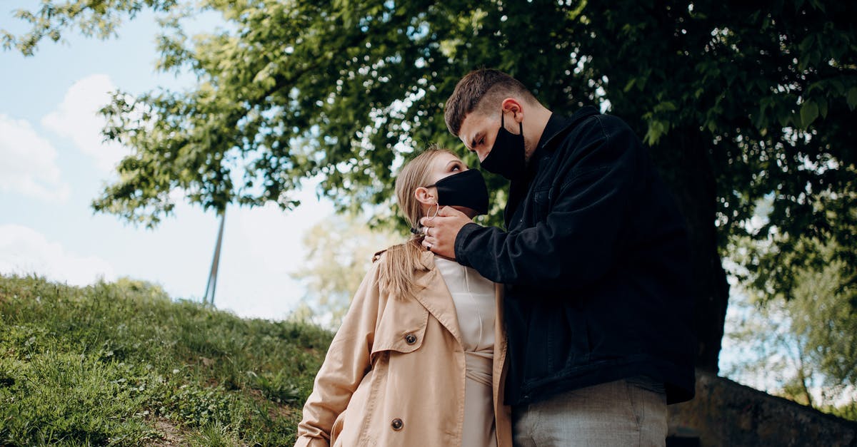 What is the purpose of the Keaton grass in Majora's Mask prologue [closed] - Young couple in stylish clothes and masks hugging and looking at each other while standing in park near tree in autumn