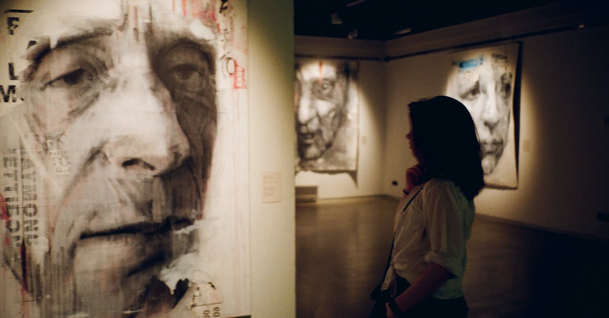 What is the purpose of the pictures on the left side of the candy crush level page? - Woman Standing in Front of Man's Painting What is the purpose of the pictures on the left side of the candy crush level page? - Woman Standing in Front of Man's Painting