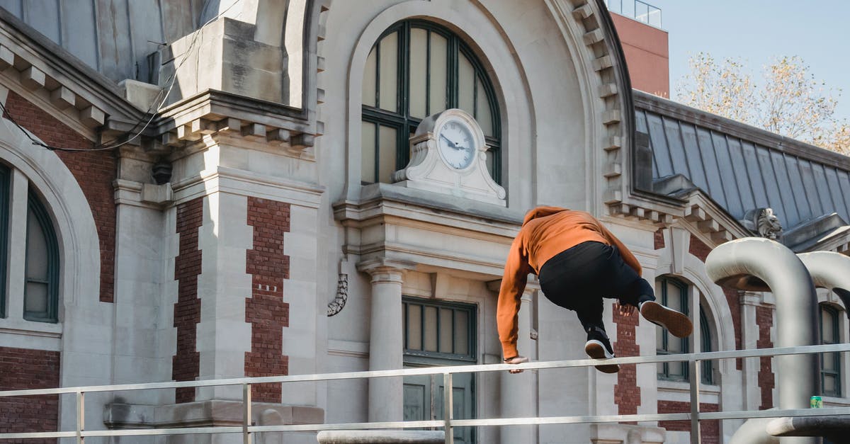 What is the "loop around the back" trick on Sky Force Reloaded? - Sportive man jumping over railing near old historic building