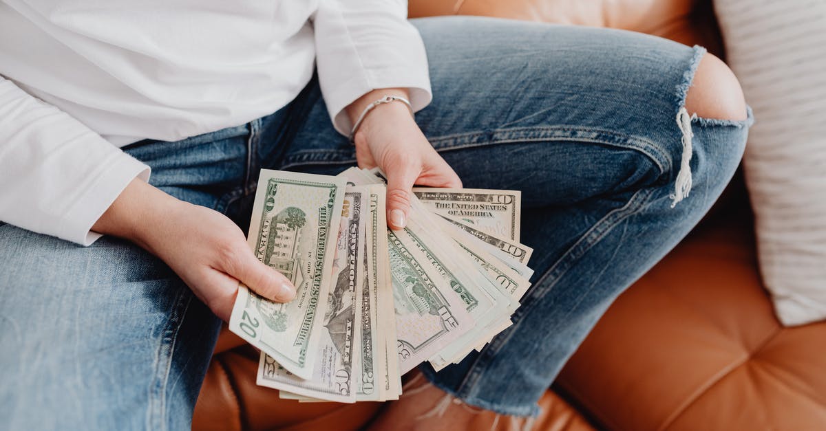 What is the range for the grenade launcher attachment? - Low Section of a Woman Sitting on a Leather Sofa and Showing Dollar Banknotes What is the range for the grenade launcher attachment? - Low Section of a Woman Sitting on a Leather Sofa and Showing Dollar Banknotes