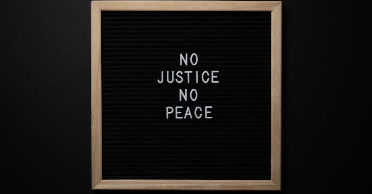 What is the significance of "The letters are worn beyond recognition"? - Overhead view of white inscription on center of chalkboard located on black background