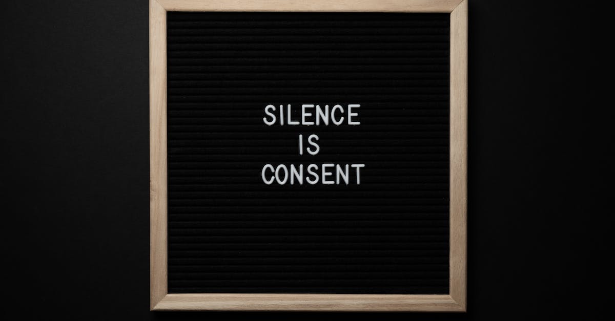 What is the significance of "The letters are worn beyond recognition"? - From above blackboard with written phrase SILENCE IS CONSENT on center on black background