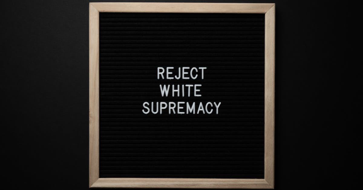 What is the significance of "Wrong Number" in Hotline Miami 2? - Top view of blackboard with written white REJECT WHITE SUPREMACY words on center on black background What is the significance of "Wrong Number" in Hotline Miami 2? - Top view of blackboard with written white REJECT WHITE SUPREMACY words on center on black background