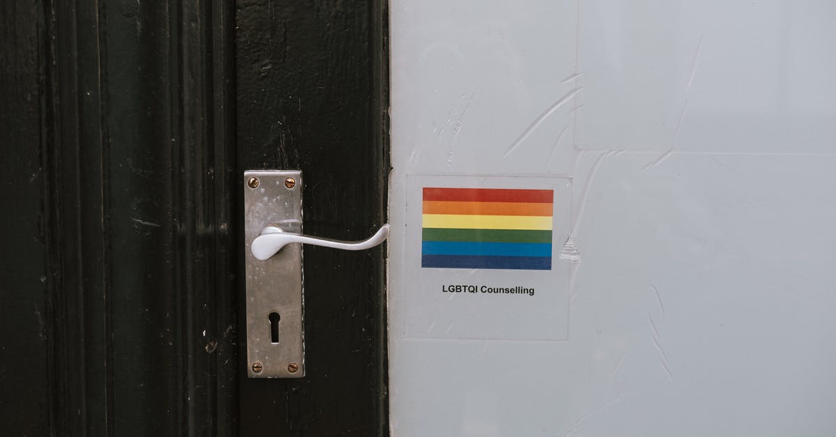 What is the symbolic meaning of the Mark of the Outsider in Dishonored? - Colorful LGBTQ symbol of lesbian gay bisexual and transgender pride on wall near door knob on black door of counselling building