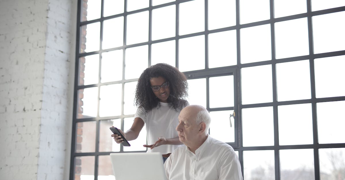 What is the use of being able to ask for advice twice? - Multiracial businesspeople of different ages using gadgets while working together in creative workplace What is the use of being able to ask for advice twice? - Multiracial businesspeople of different ages using gadgets while working together in creative workplace