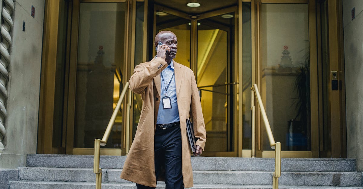 What is the use of building boats? - Pensive black man talking on phone walking down stairs