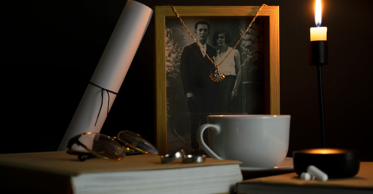 What is the use to the memories that you unlock? - Pendant Hanging on a Black and White Photograph in a Frame 