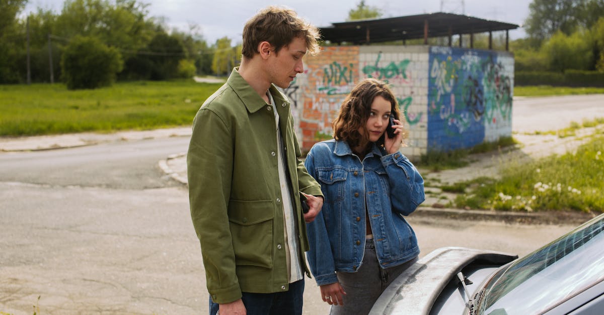 What is the vehicle despawn radius? - Man and Woman Standing Beside Car