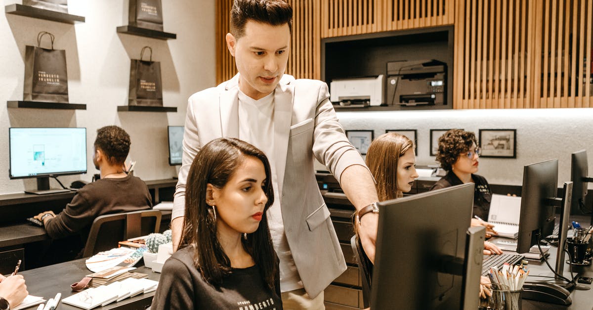 What is there to gain when helping people with bosses? - Man Teaching Woman in Front of Monitor