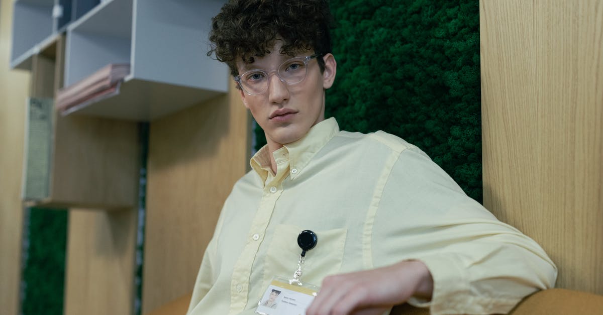 What is this badge? - Man in White Dress Shirt Holding White Paper What is this badge? - Man in White Dress Shirt Holding White Paper