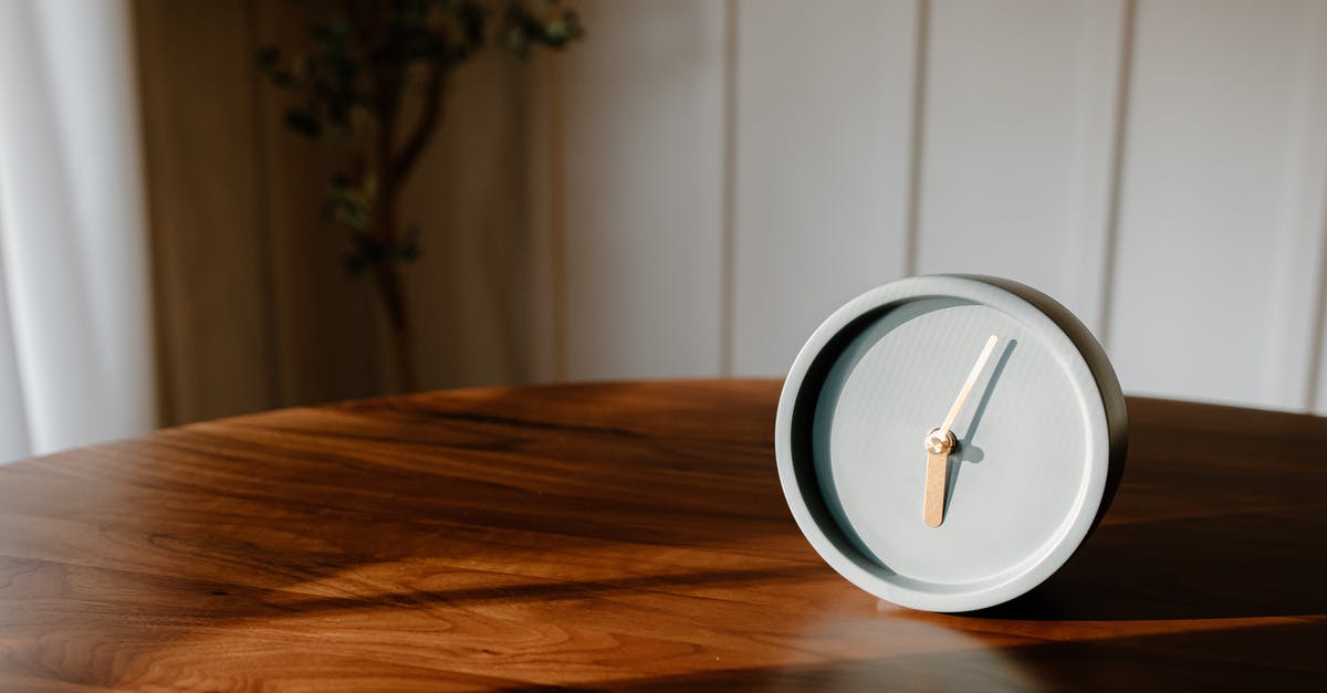 What is this clock next to my roblox username? - Gray Analog Clock on a Wooden Table