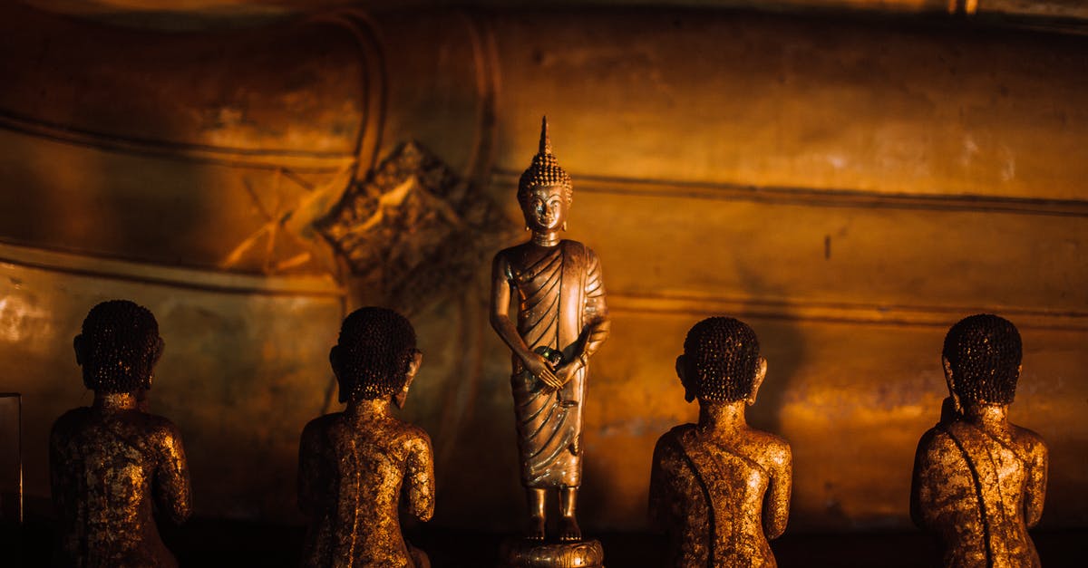What is this golden sword? - Gold Buddha Figurine on Brown Wooden Table What is this golden sword? - Gold Buddha Figurine on Brown Wooden Table