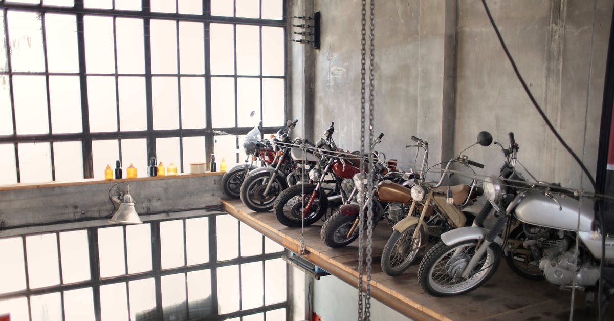 What is this machine in Wall Market? - Retro motorbikes parked in row on special platform in garage